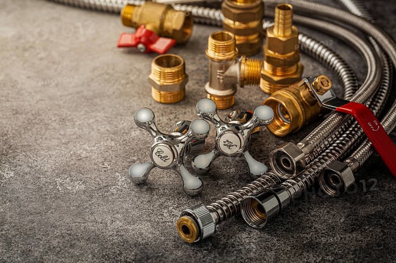Bathroom Flexible Hoses Pipes And Brass Pipe Fixtures Fittings On Dark Background