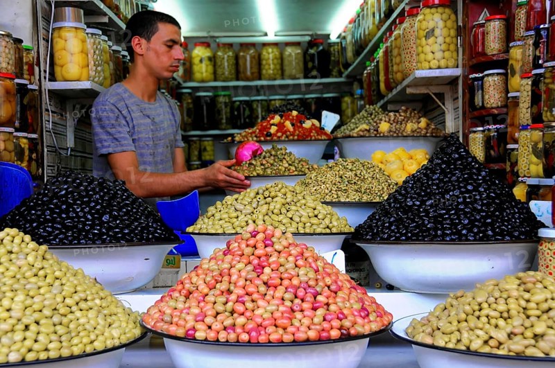 UNESCO World Heritage Site, Marrakech, Morocco, Africa, Different types of olives in large bowls on a market stall with a vendor, Africa