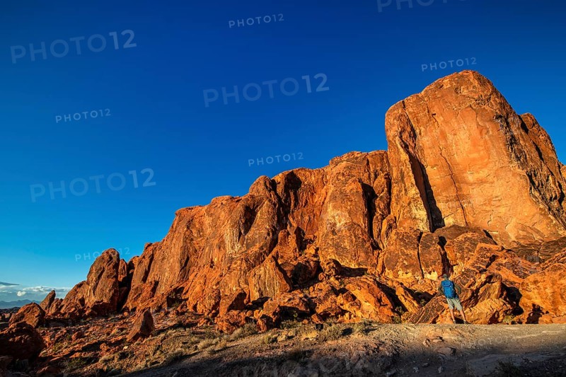 Hiker in front of Gibraltar Rock, Valley of Fire State Park, Nevada, USA, North America