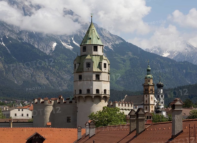 Austrian Hall in Tyrol. Mint tower built at the end of the 15th century. Tower of Hasegg Castle and landmark of the town. Today part of the Hall Mint Museum. In the background the collegiate church and the Jesuit church
