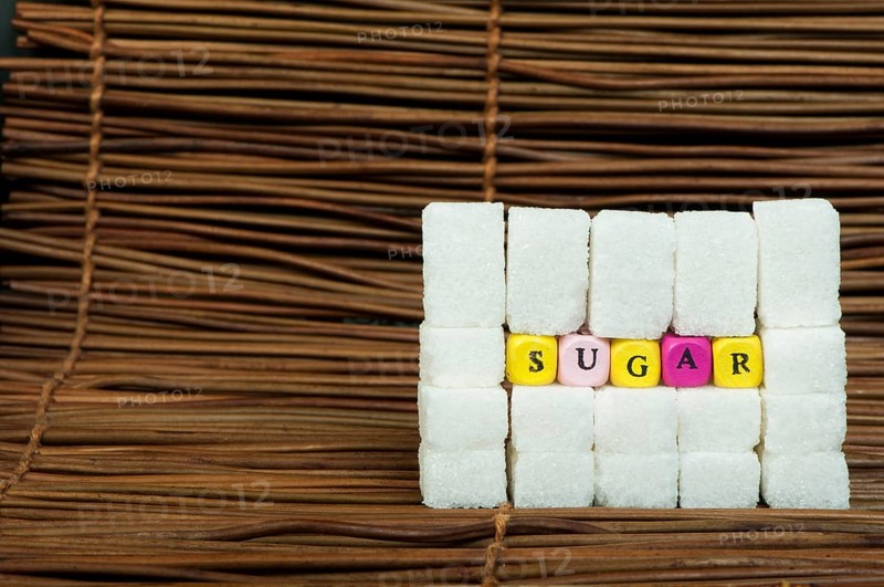 Sugar lumps and word sugar. Multicoloured cubes