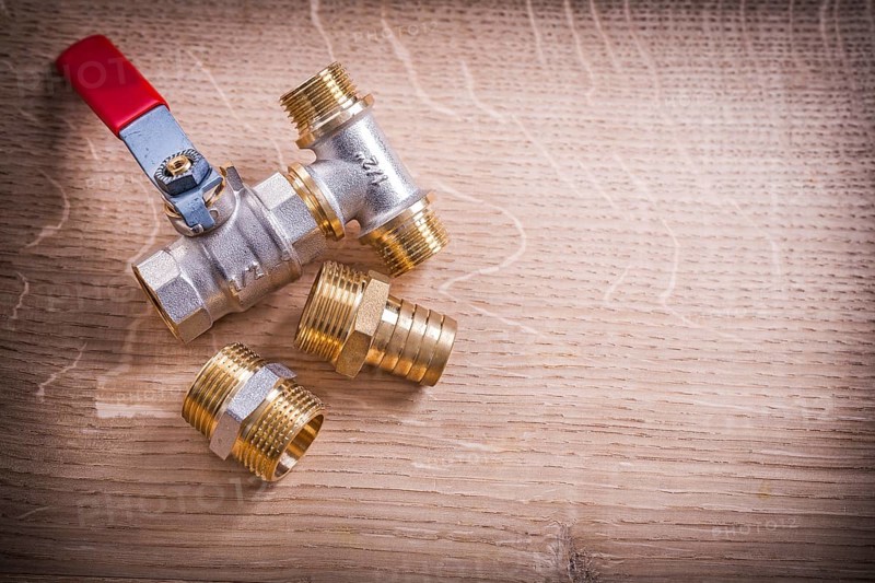 Aerial View Brass Pipe Connectors On Wooden Board