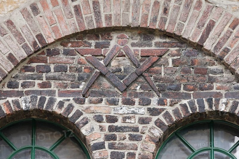 Door of the former blacksmith's workshop, wall relief with compass and drawing triangle, possibly a craftsman's mark
