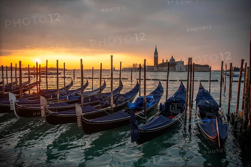 Cloudy atmosphere at sunrise, gondolas, San Giorgio Maggiore church in the background, Venice, Veneto, Italy, Europe