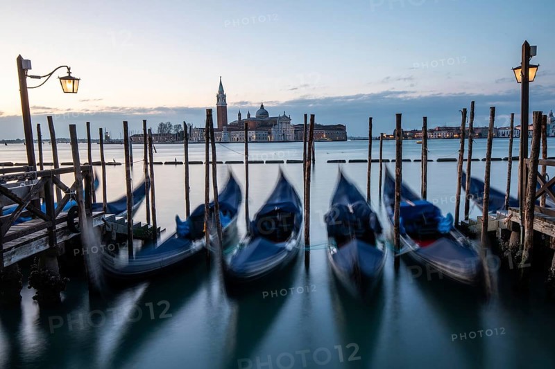Morning light in front of sunrise, Venetian gondolas, boat dock at St Mark's Square, church of San Giorgio Maggiore in the background, Venice, Veneto, Italy, Europe