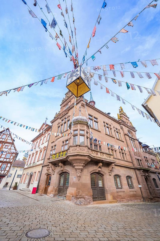Historic building with colourful pennants on a cobblestone square, Meßkirch, Sigmaringen district, Germany, Europe