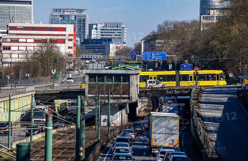 Motorway A40, Ruhr expressway, heavy traffic jam, rush hour, city passage in Essen, skyline of the city centre, underground line between the lanes, Hobeisenbrücke stop, North Rhine-Westphalia, Germany, Europe