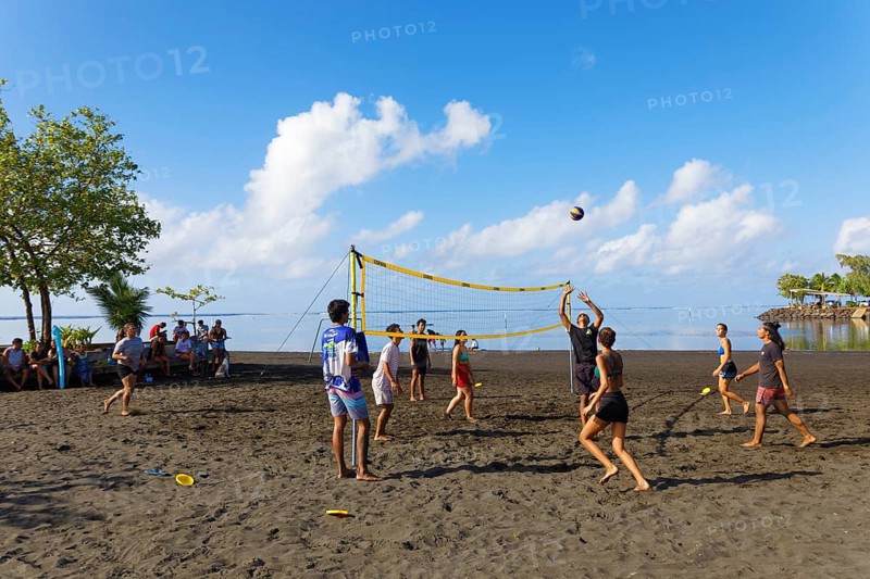 Young people playing volleyball on the beach, black, sand, Matavai Bay, Pointe Venus, Mahina Tahiti-Nui commune, Society Islands, Leeward Islands, French Polynesia, Oceania