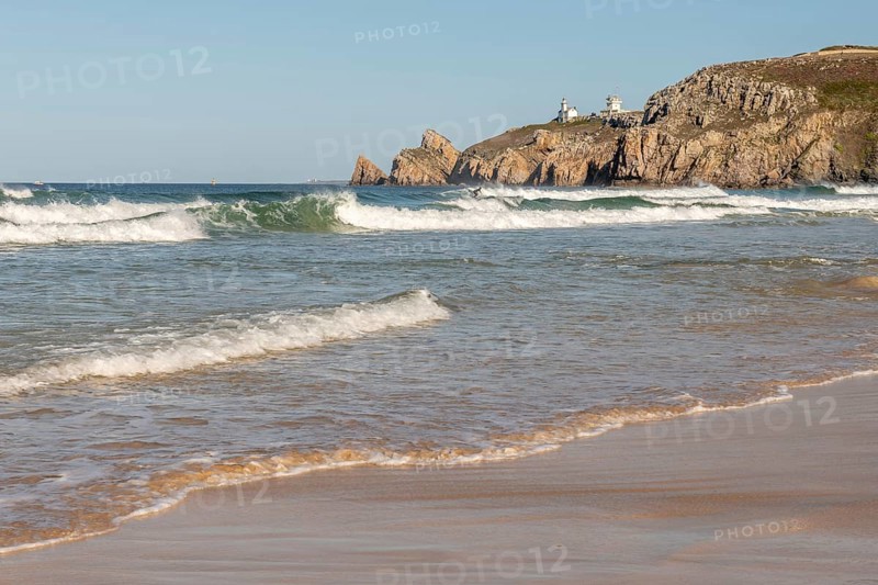 The sea is calm and the beach is sandy. The waves are small and the water is a light blue colour. Camaret sur mer, Crozon, Finistere, Brittany, France, Europe