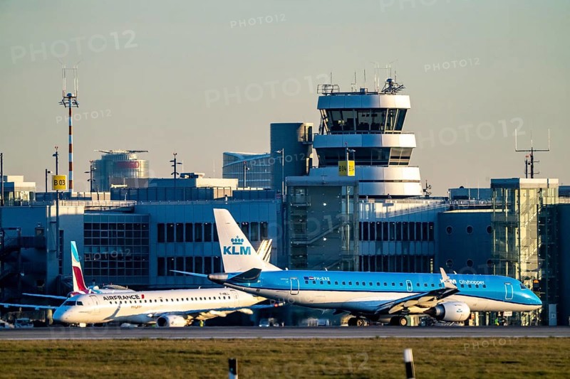KLM Cityhopper aircraft on the taxiway, apron of Düsseldorf International Airport, old air traffic control tower, North Rhine-Westphalia, Germany, Europe