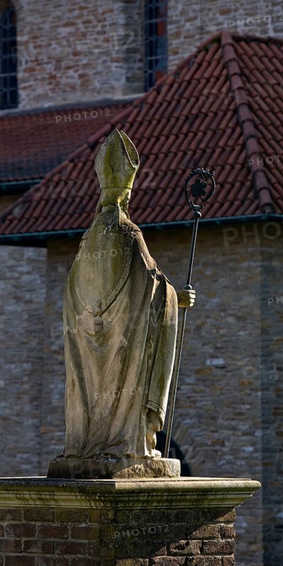 Statue of Bishop Boniface in front of the collegiate church of St Boniface, Freckenhorst, Warendorf, Münsterland, North Rhine-Westphalia, Germany, Europe