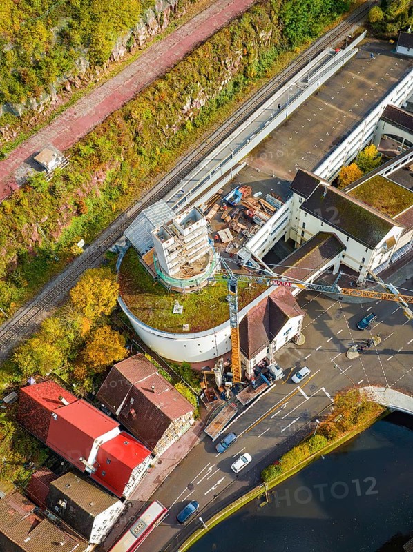 Roof photo of a building site with crane, concrete tower and surrounding red house roofs, extension of the ZOB Calw tower onto the new track of the Hermann Hesse railway, Calw, Black Forest, Germany, Europe