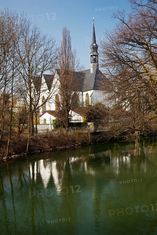 The Church of the Brethren is reflected in the River Lippe in spring in Lippstadt, North Rhine-Westphalia, Germany, Europe