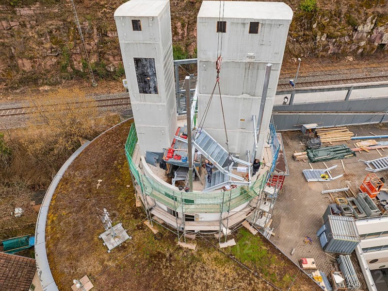 Construction operation with materials and crane on two towers near a railway line, extension of the ZOB Calw tower to the new track of the Hermann Hesse railway, Calw, Black Forest, Germany, Europe