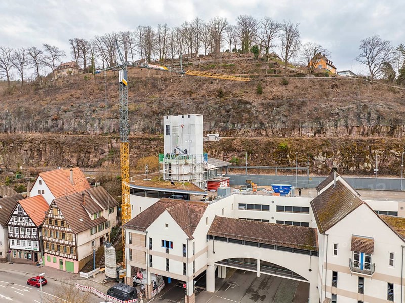 Cityscape with construction site, concrete tower, crane and surrounding historical architecture, extension of the ZOB Calw tower onto the new track of the Hermann Hesse railway, Calw, Black Forest, Germany, Europe