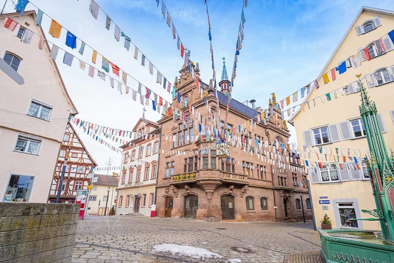 Historic building with colourful pennants and half-timbered houses on a cobbled square, Meßkirch, Sigmaringen district, Germany, Europe