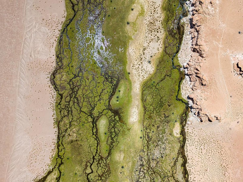 Rio Punilla, Los Nacimientos, Catamarca Province, Argentina, Aerial shot of a desert terrain with green patches and unique patterns, South America, Aerial view of green and sandy textures with rock formations in a desert setting, South America, Argentina, South America