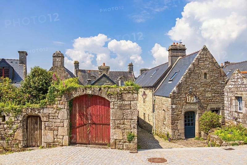 Idyllic old preserved French village with stone houses and wooden doors a sunny summer day, Locronan, Bretagne, France, Europe