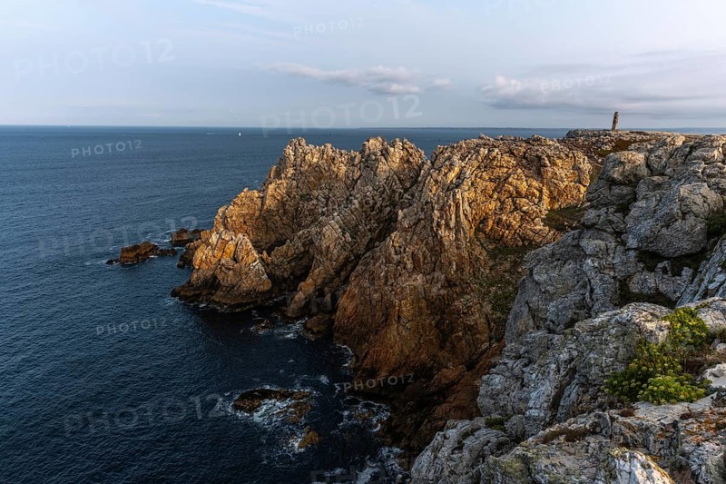 The tip of Pen Hir. The rocks are jagged and rough, the water is calm. The scenery is peaceful. Camaret sur mer, Crozon, Finistere, France, Europe