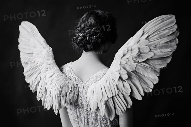 Black and white image of young female angel with white feather wings on back. Generative AI, AI generated
