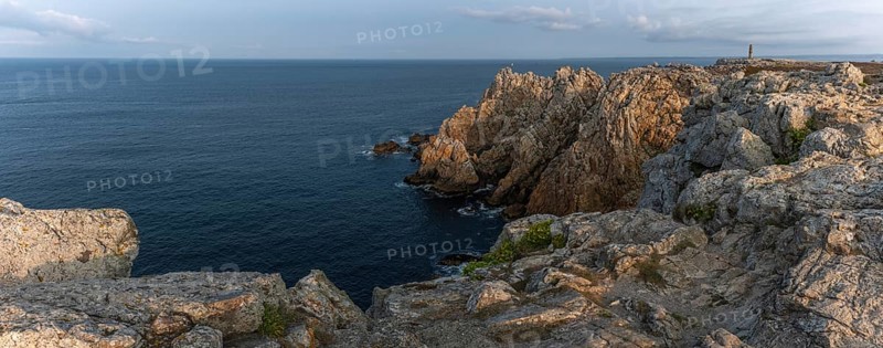 The tip of Pen Hir. The rocks are jagged and rough, the water is calm. The scenery is peaceful. Camaret sur mer, Crozon, Finistere, France, Europe