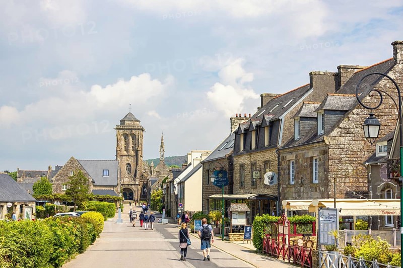 Old town Locronan with tourist walking on the street by the old houses and the old church, Locronan, Bretagne, France, Europe