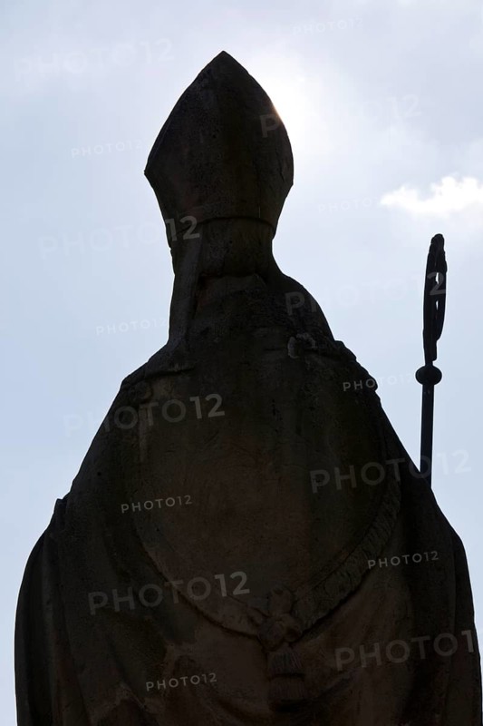 Statue of Bishop Boniface with mitre and crozier against the light, Freckenhorst, Münsterland, North Rhine-Westphalia, Germany, Europe