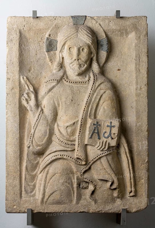 Brauweiler near Pulheim, Abbey Church of St Nicholas, Lapidary, Christ Enthroned from the west gable of the north aisle. 11th-12th century. Cross and the letters alpha and omega made of lead