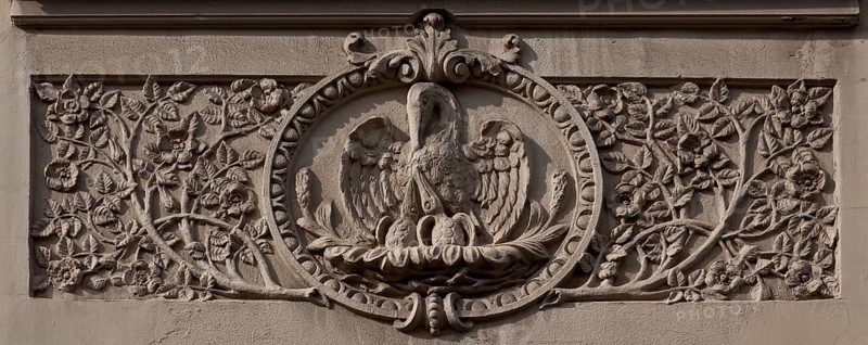Halle an der Saale. Residential building at Geiststraße 29, Art Nouveau stucco relief. Bible quotation: Pelican feeds its young with its blood as a symbol of Christian love