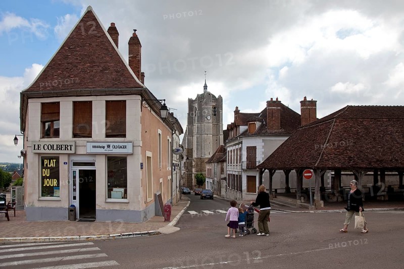 Seignealy. Tower of Saint-Martial built 10-17th century and partial view of the 17th century market hall, St., St., Saint