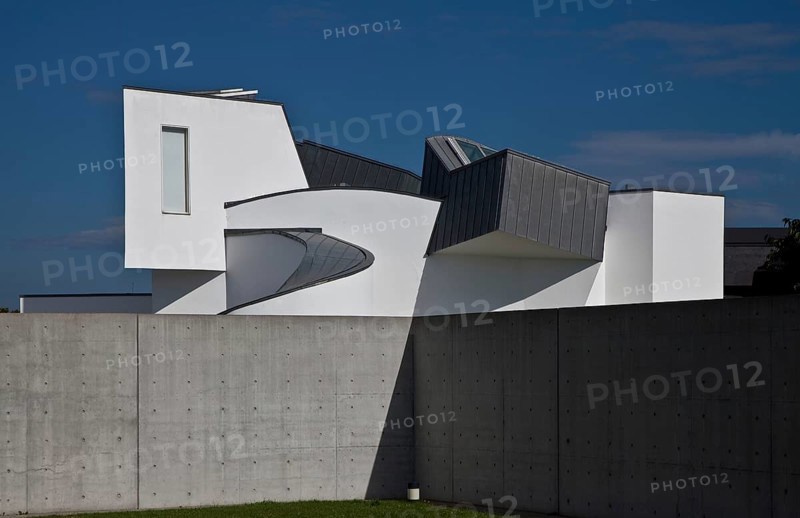 Frank O. Gehry, 1989, seen over a wall of the conference pavilion by Tadao Ando