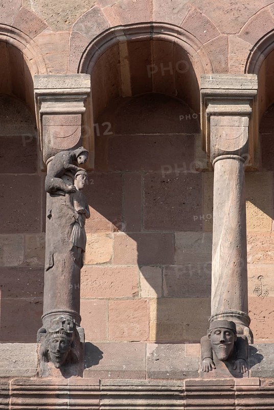 Worms, St Peter's Cathedral, east choir, figure on the dwarf gallery, master builder with the monkey, stonemason's mark on the right