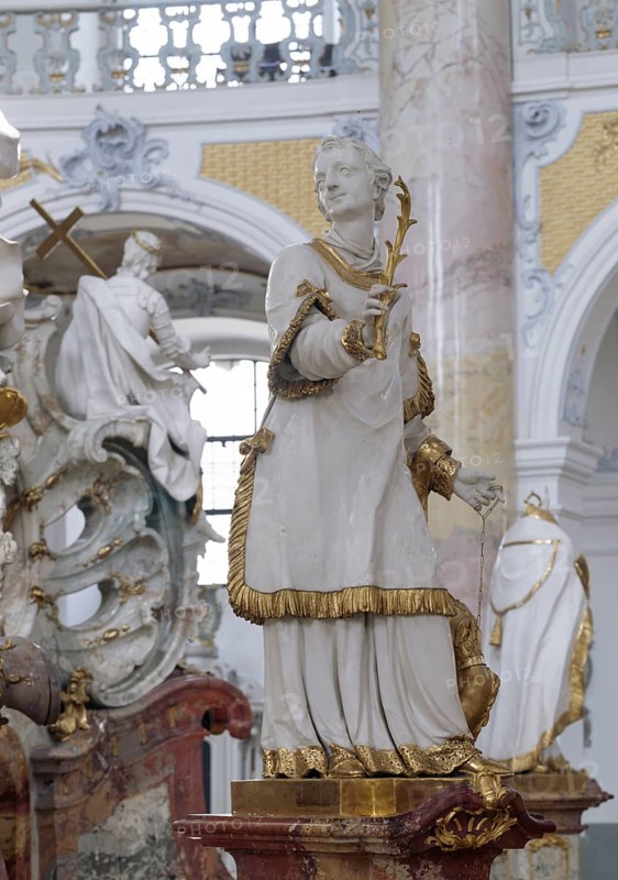 St Cyriacus at the altar of grace. The Vierzehnheiligen Basilica near Bad Staffelstein in the district of Lichtenfels is a pilgrimage church in Upper Franconia. The church, built according to plans by Balthasar Neumann, is dedicated to the Fourteen Saint Helpers and receives around half a million visitors a year