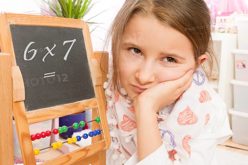 Frustration at school, arithmetic, lack of concentration, 7 year old girl looks unhappy and thoughtful, frustration, lus'tlos