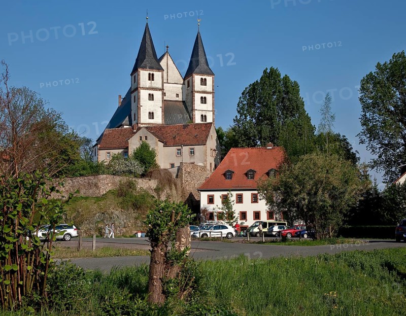 View of the village from the west with Romanesque double tower façade and west gable of the high hall roof, St., Sankt, Saint