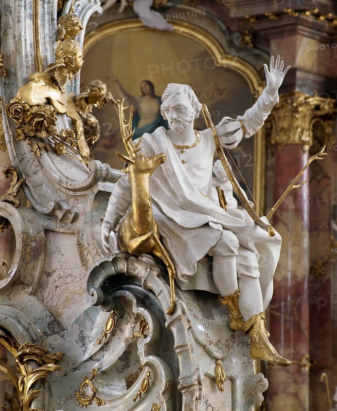 St Eustachius at the altar of grace. The Vierzehnheiligen Basilica near Bad Staffelstein in the district of Lichtenfels is a pilgrimage church in Upper Franconia. The church, built according to plans by Balthasar Neumann, is dedicated to the Fourteen Saint Helpers and receives around half a million visitors a year