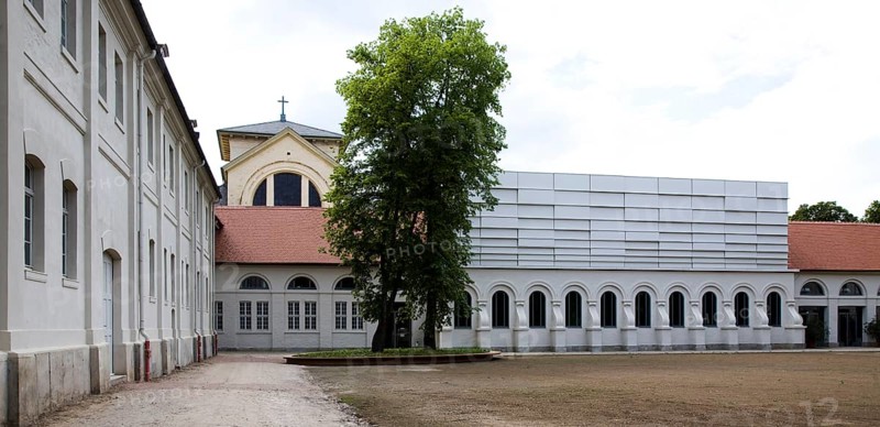 Concert hall in former riding arena, castle church behind it