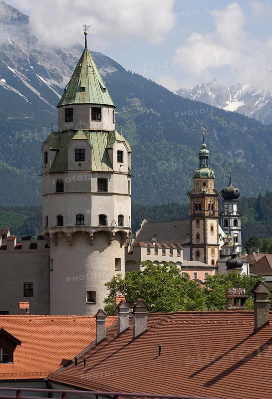 Austrian Hall in Tyrol. Mint tower built at the end of the 15th century. Tower of Hasegg Castle and landmark of the town. Today part of the Hall Mint Museum. In the background the collegiate church and the Jesuit church
