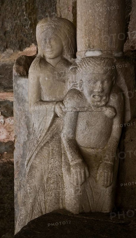 Collegiate church, south portal, woman ties up devil with chain, St., Saint, Saint
