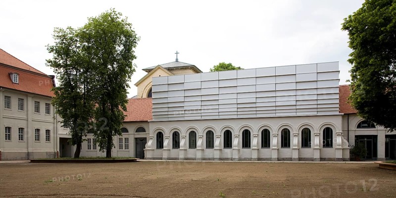 Concert hall in former riding arena, castle church behind it