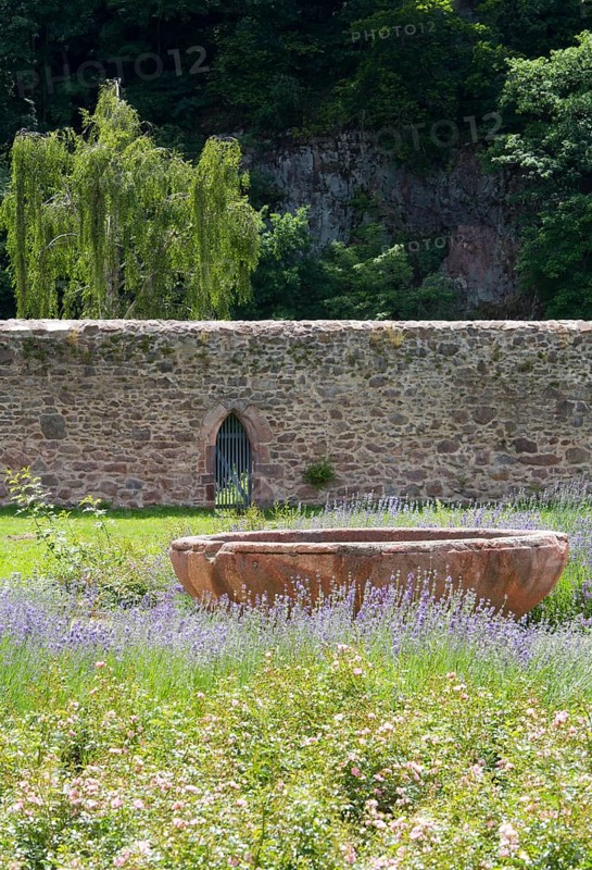 Monastery wall and fountain bowl in the former cloister