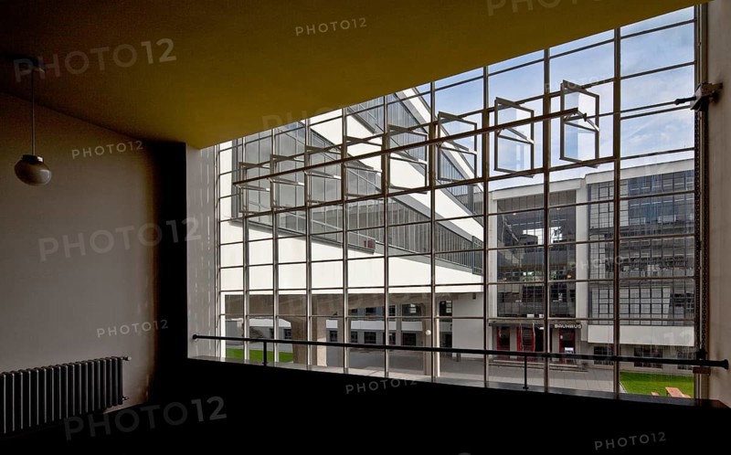 View through the stairwell window of the former vocational school between the ground floor and first floor to the bridge and main entrance