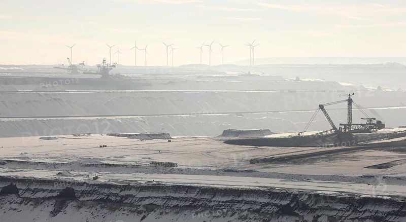 Landscape in the snow, wind turbines in the background