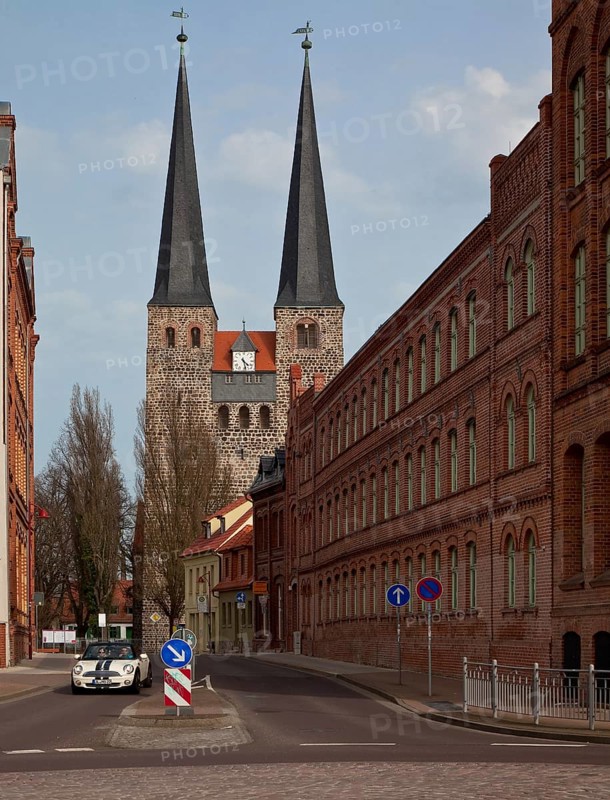 Burg near Magdeburg, lower church of St Nicolai. View from the west through Magdeburger Stra§e. On the right former shoe factory Conrad Tack & Cie built 1888-1906, St, Sankt, Saint