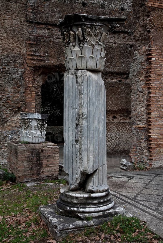 Column fragment in front of the triclinium