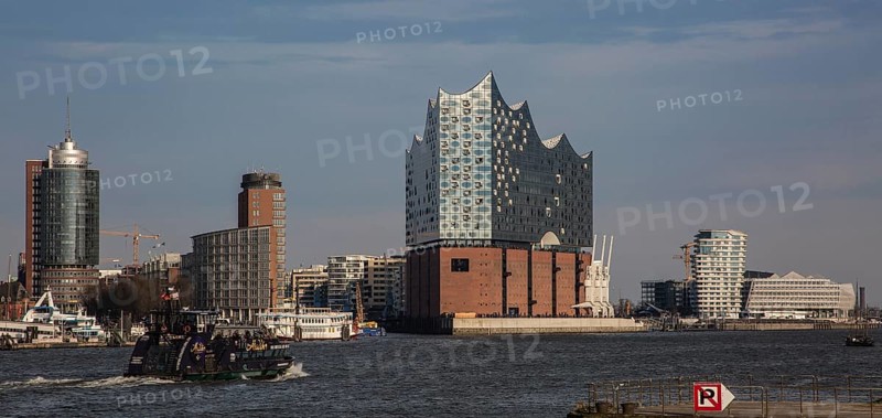 Hamburg, Elbphilharmonie, distant view from the south-west, designed by Herzog & de Meuron, built 2007-2016, brick base formed by the former Kaispeicher A warehouse built in 1963