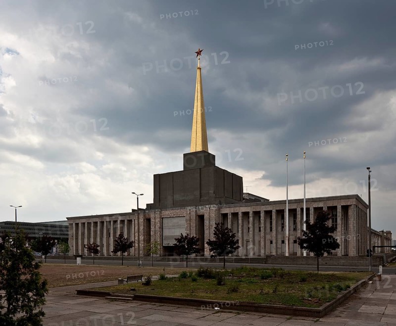 Exhibition hall 1923-1924 with pillared porch in front, 1950-51 tower construction with gilded spire and Soviet star