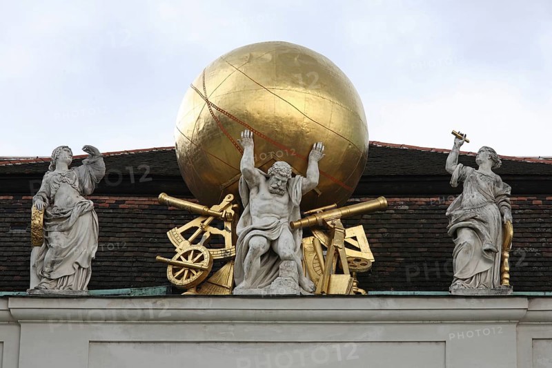 Stone atlas on the gable of the Court Library, now the National Library Globe, globe, golden, sword, stretcher, sextant, telescope, compass