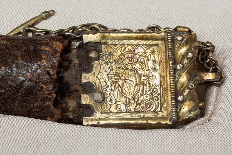 Belt of St Liudger, silver buckle with relief of St Liudger in episcopal regalia with a model of a church and geese at his feet
