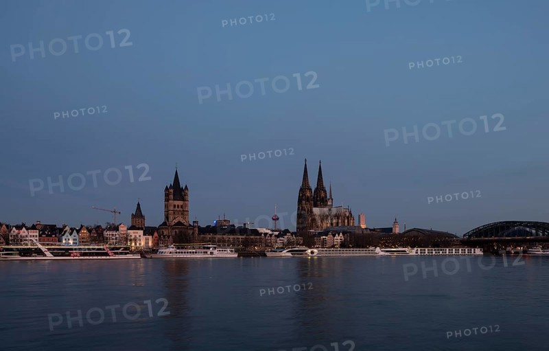 Cologne, view from the right bank of the Rhine to the cathedral, St Martin's Cathedral and the town hall shortly in front of sunrise